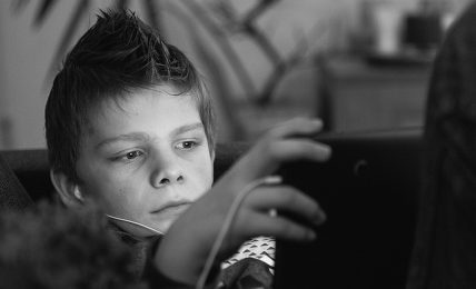 kid playing games on a laptop